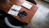 Newspaper on a table with a digital tablet mockup