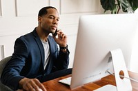 Casual businessman talking on a phone while working in the office