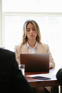 Successful woman in a meeting using a laptop