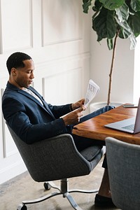 Black businessman reading a newspaper