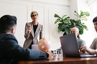 Businesswoman explaining a business plan to team