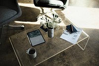 Digital tablet mockup by a vase with white carnation flowers