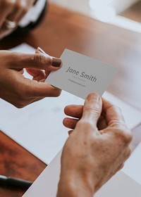 Woman handing a business card mockup