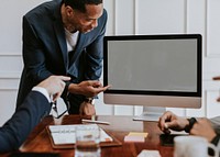 Businessman presenting a project on a computer desktop