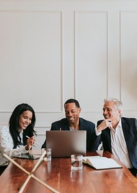 Happy business people using a laptop