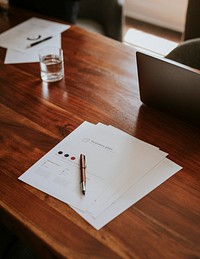 Signing documents in an office on a wooden desk