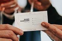 Senior businessman handing a business card mockup