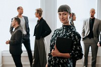 Confident businesswoman standing with a digital tablet