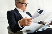 Senior businessman reading a newspaper