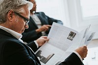 Senior businessman reading a newspaper