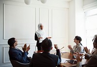 Muslim businesswoman presenting in an office meeting