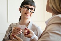 Woman handing a business card in a meeting