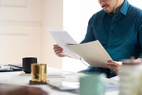 Businessman sitting on his desk reading a document