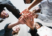 Business people stacking hands in the middle