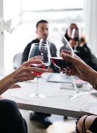 Colleagues toasting wine glasses at work