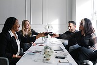 Colleagues toasting wine glasses at work