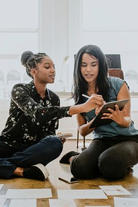 Businesswomen working together using a digital tablet