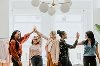 Businesswomen giving a high five to team