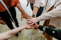 Business people stacking hands in the middle