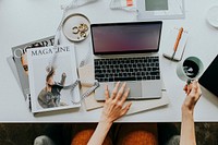 Female blogger working on her laptop at home