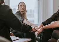 Business people stacking hands in the middle