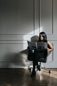 Black woman reading a newspaper