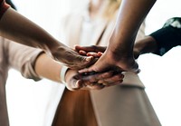 Business people stacking hands in the middle