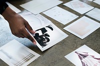 Designer laying out images on the floor
