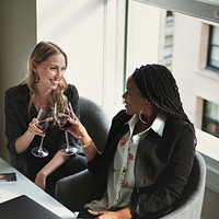 Happy businesswomen toasting in the office