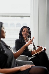 Black woman with a notepad in a meeting