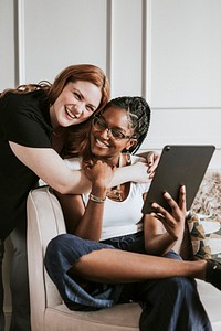 Lesbian couple taking a selfie with a digital tablet