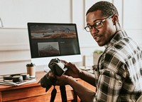 Black photographer working on his desk