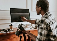 Photographer checking photo on computer