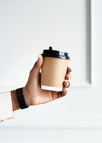Black woman holding a coffee to go