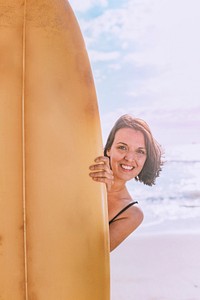 Happy woman holding a surfboard mockup