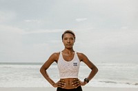 Confident sporty black woman on the beach