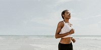 Black woman jogging on the beach