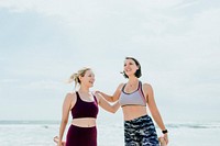 Happy women stretching at the beach