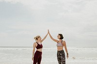 Cheerful sporty women bonding at the beach