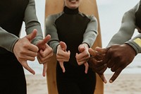 Cheerful surfers doing the shaka sign