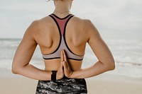 Woman doing namaste behind her back