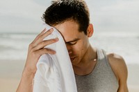 Man relaxing after workout on the beach