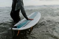 Man at the beach with his surfboard