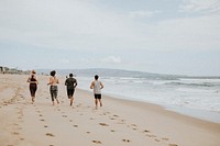 Friends running together at the beach