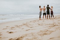 Diverse friends stretching at the beach
