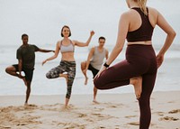 Athletic people stretching at the beach