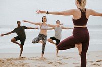 Athletic people stretching at the beach