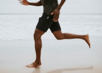 Black man running on the beach