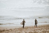 Surfers running on the beach