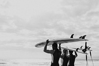 Happy friends surfing at the beach